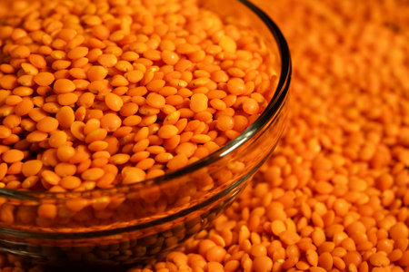 Red lentils in bowl on a lentils background.の写真素材