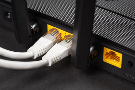 Connect an Ethernet Cable to a Wireless Router on dark. Ethernet, rj45 and electric cables,...