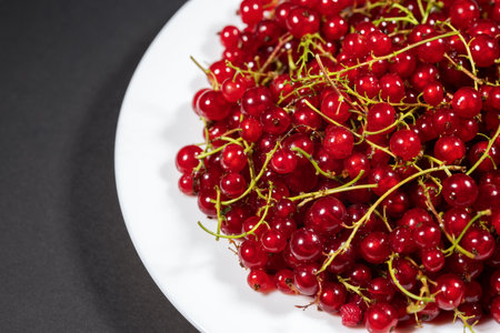 natural, juicy red currents in a white, close-up selective focus.の写真素材