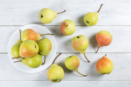 Fresh pear fruit on plate with white table, Healthy fruit.の写真素材