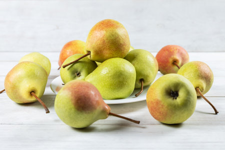 Fresh pear fruit on plate with white table, Healthy fruit.の写真素材