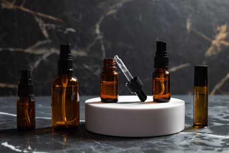 Amber bottles with facial cosmetics on the dark background.の写真素材