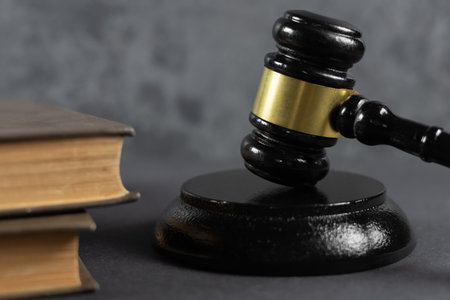Lawyer or judge's hammer in court. The auction hammer is on the wood table. Legal subject or auction company with book.の写真素材