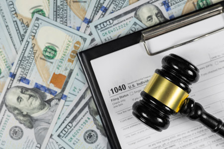 Judge's gavel on the tax form with money. Tax law. Top view.の写真素材