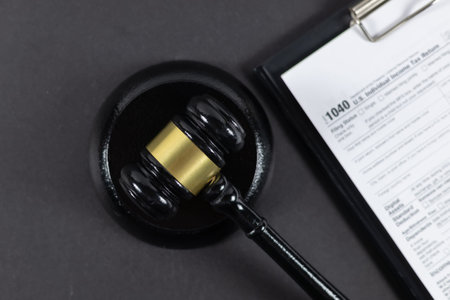 Judge's gavel over 1040 US Tax form.