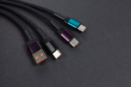 Various USB charger cable connectors on dark background.の写真素材