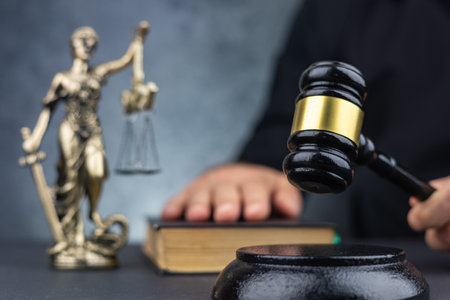 Judge's gavel on Themis statue background. Law theme concept. Mallet of the judge for sentencing.の写真素材