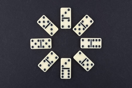 Classic domino tiles on black background, flat lay. Space for text.の写真素材