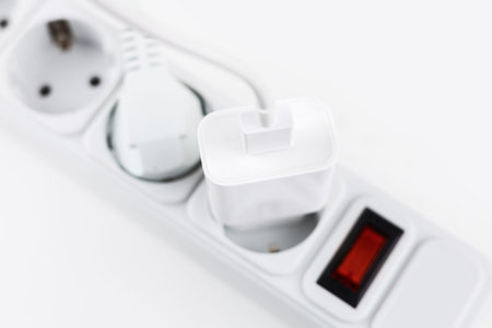 mobile phone chargers connected to electrical power strip. Various charging concept,