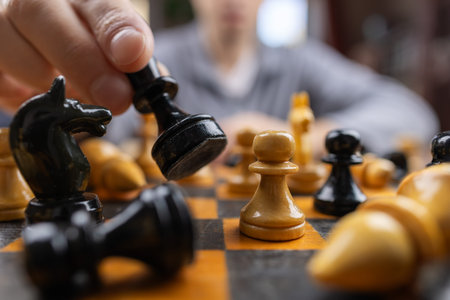 Hand of player chess using Minor piece, illustrate business strategy for win and success.