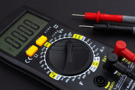 Digital multimeter on dark background.