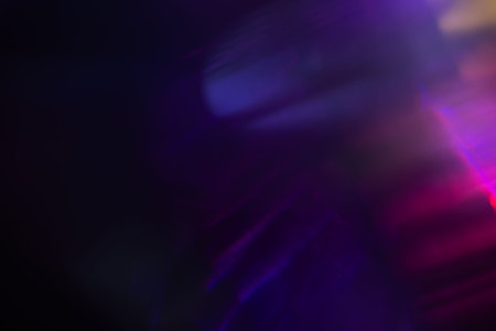 Abstract blurred colorful lens flare bokeh on black