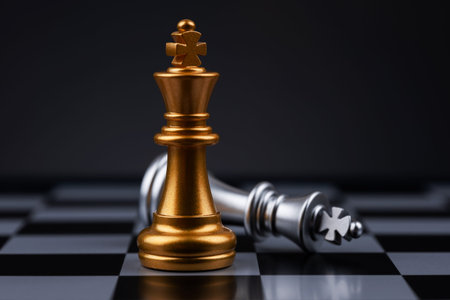 chess pieces The golden king stood beside the fallen silver king.
