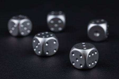 five silver dice view from above on black background.