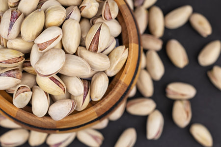 Roasted and Salted Pistachios in a Bowl on a gray background.
