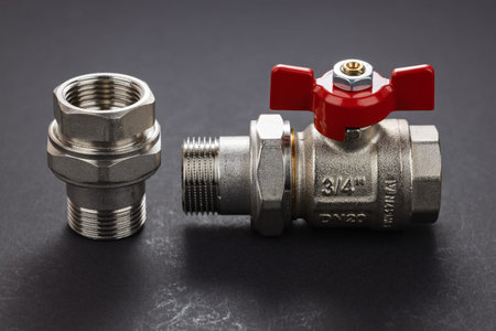 water ball valve with connecting fitting, on dark background. Threaded connection American.