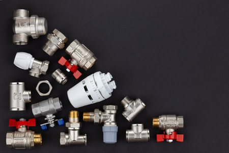 water ball valve with connecting fitting, on dark background.