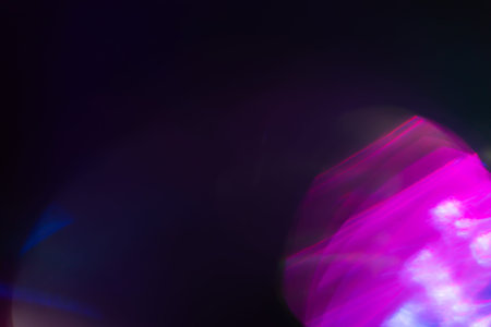Colorful light leak on black background, abstract design with optical lens flare shot on a long...
