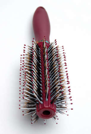 red hairbrush isolated on white backgroundの写真素材
