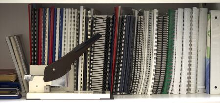 Texture of shelves with books in the office. Bookshelf in the office with documentation.の写真素材