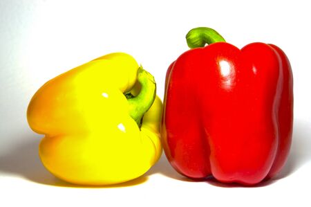 yellow and red bell peppers paprika on a white backgroundの写真素材