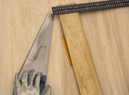 Carpenter at work, makes crafts from boards and plywoodの写真素材