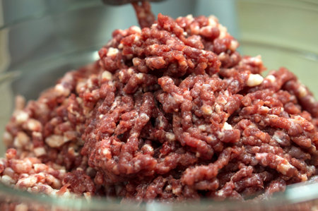 Grilled beef meat in a meat grinder. Minced meat