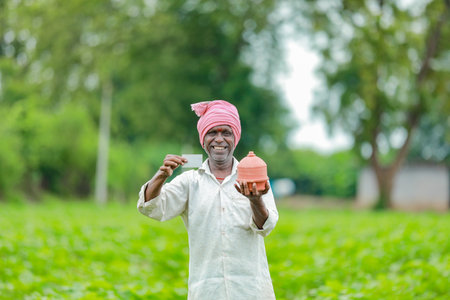 Indian farmer Holding ATM card in hands , happy indian farmer, poor farmer, workerの写真素材