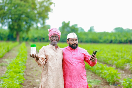 Indian farming. two farmer holding empty bottle in hands, farmer and agronomistの写真素材