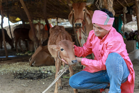 Happy Indian farmer selling milk in farm - concept of milk production agri busines, rural India, growth and agricultureの写真素材