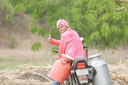 Indian farmer selling milk on bikeの写真素材
