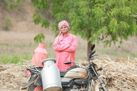 Indian farmer selling milk on bikeの写真素材