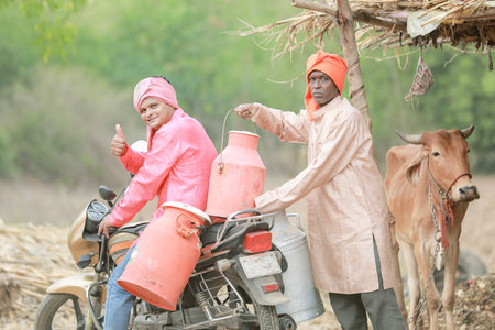 Indian farmer selling milk on bikeの写真素材