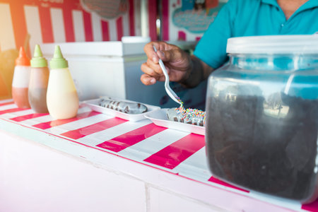 Unrecognizable man preparing a banana ice cream inside a truckの写真素材