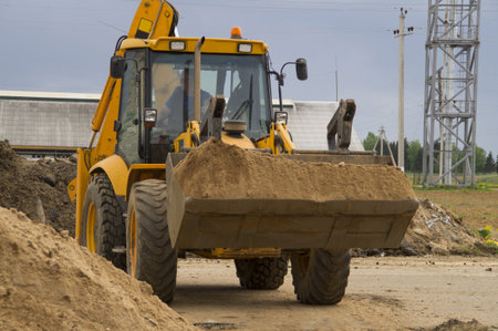 Small truck transporting sand on a construction site