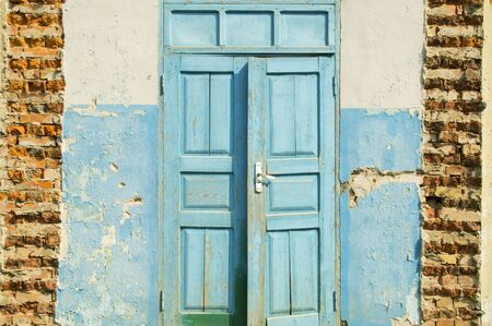 old wooden swing door in an abandoned buildingの写真素材