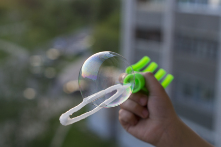 Boy blowing bubblesの写真素材