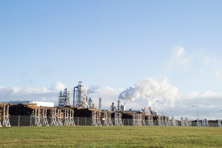 Industrial landscape with oil refinery plant and blue sky with white cloudsの写真素材