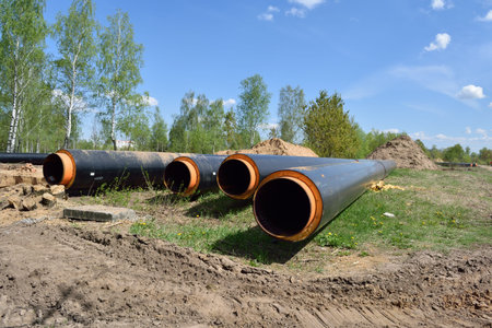 Pipeline for water supply in the construction site on a background of blue sky