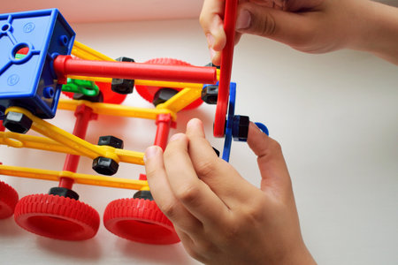 Close-up of a child's hands playing with educational toys.の写真素材