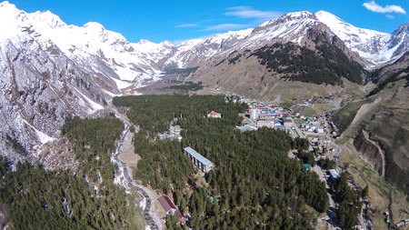 View from the height of a bird's flight to Elbrus valley and to Elbrus mountain in Russian North Caucasus. Morning in Caucasus mountains. Shooting with quadrocopterの写真素材