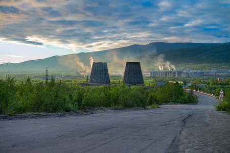 Beautiful and wild tundra of the Arctic in Russia and industrial plant. Works throw their waste into the atmosphere. The beauty of these places could be lost forever. Take care of nature!の写真素材