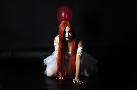 a girl in a clown costume with scary makeupの写真素材