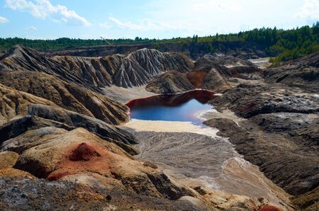 mountains of red clay in the Urals.other planet. The color of iron and the atmosphere of Mars. Unusual terrain. Red river.selective focusの写真素材