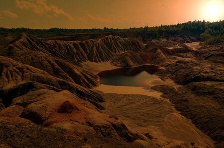 mountains of red clay in the Urals.other planet. The color of iron and the atmosphere of Mars. Unusual terrain. Red river.selective focusの写真素材