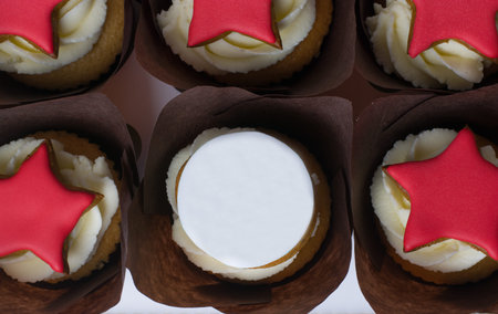 cupcakes with cream and red stars on a white background