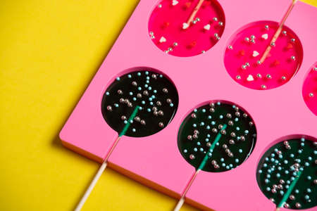 lollipops on a stick in a single form for cooking on a yellow background.の写真素材