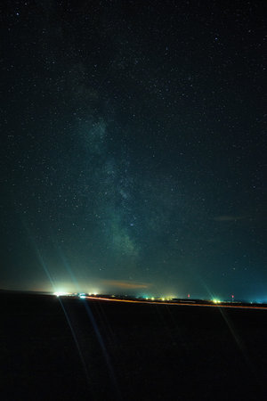 Milky Way over the road in the night sky. Long exposure photograph.