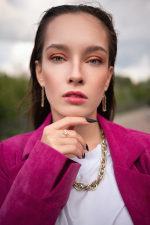 Stylish Young Woman in Magenta Blazer with Gold Jewelry . Fashion Portraitの写真素材