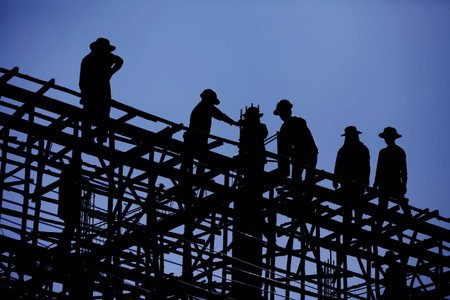 Construction worker is working on steel roof , silhouette , blue sky